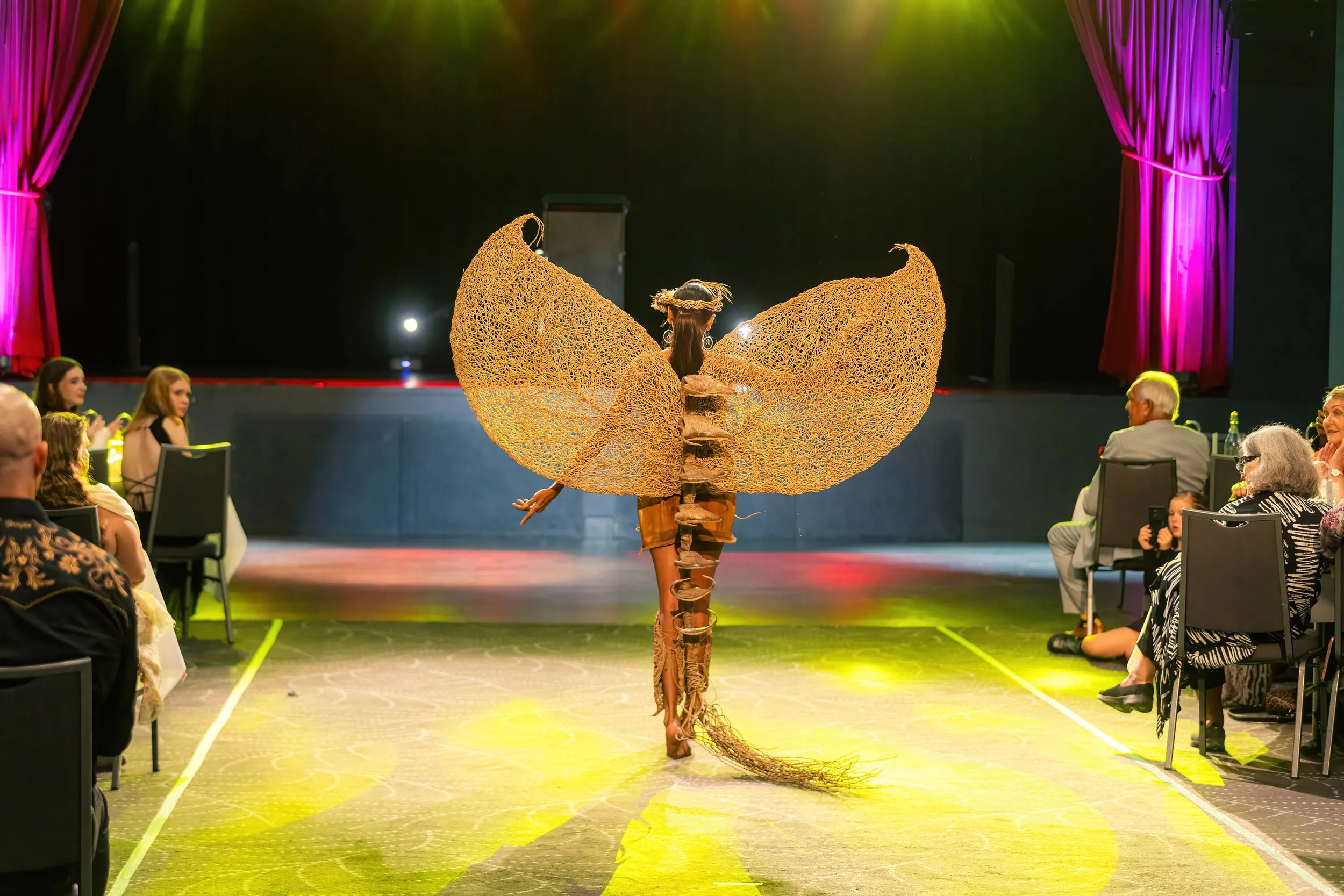 Woven wings under the lights at Fashique Runway, Brisbane, 2026, photographed by Kris Cook