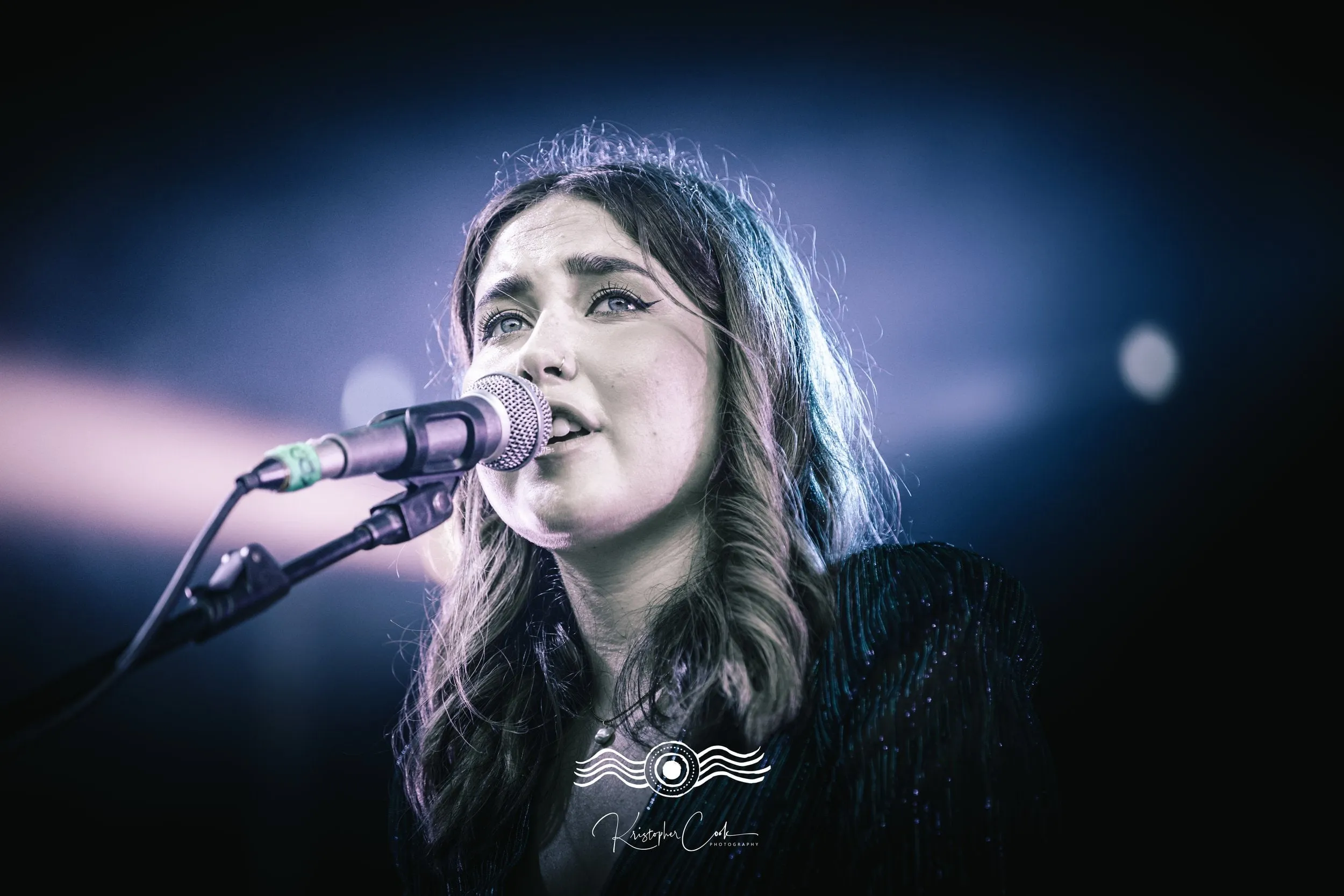 Singer at the mic on stage at Groove on the Grass, Grafton, 2023, photographed by Kris Cook